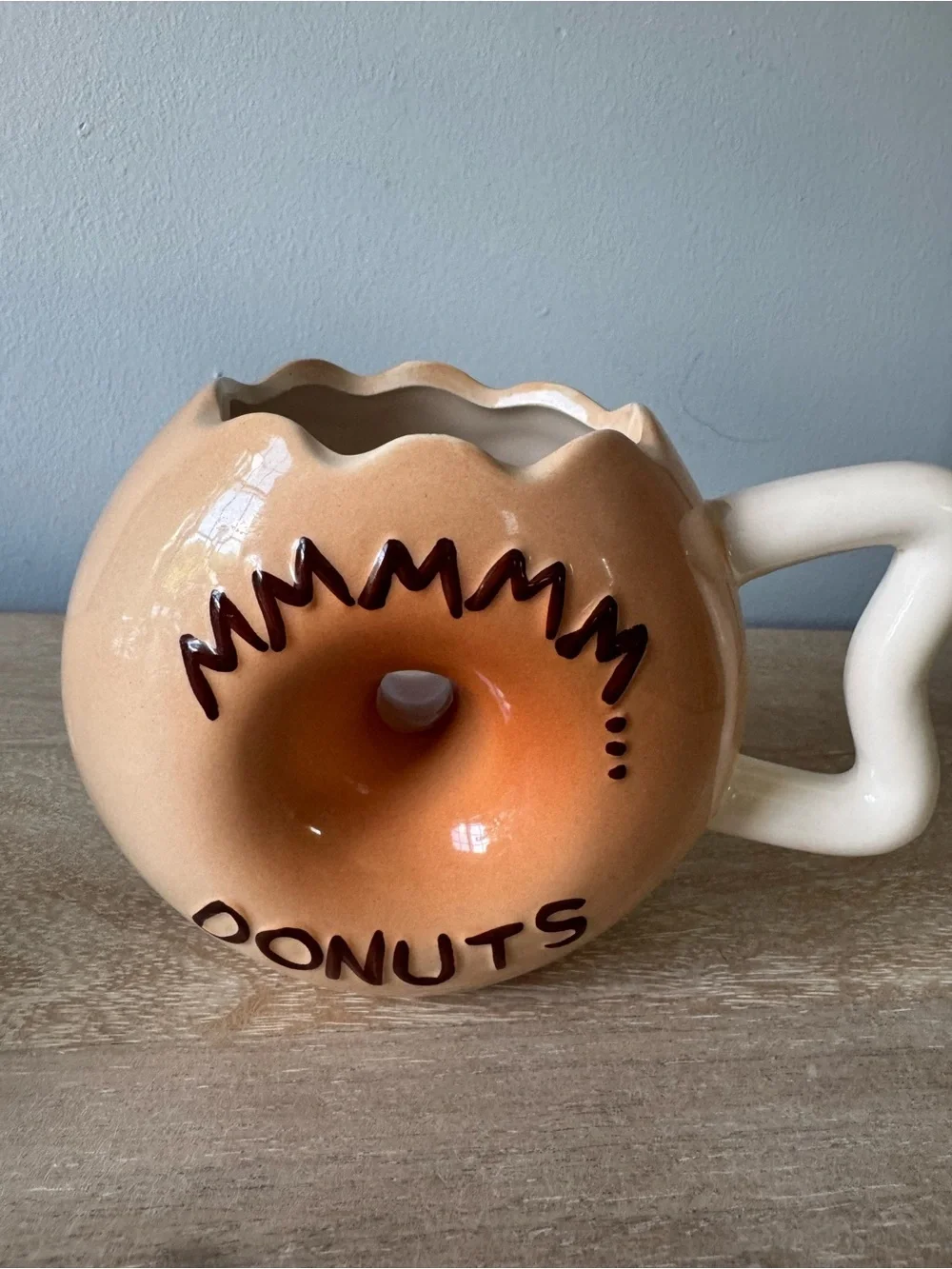 Donut-Shaped Ceramic Mug with Black Frosting and Tan Body